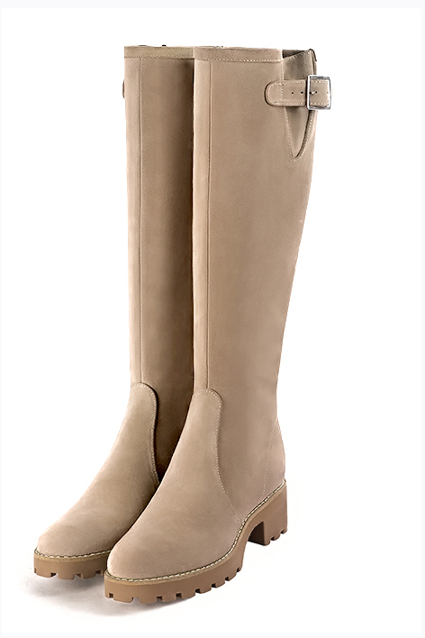 Handcrafted tall leather boots detailed with elegant adjustable buckles, providing stylish leg support and custom-made calf sizing, in sand leather with  and 